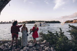 Three people on the shore of Baltic Sea.