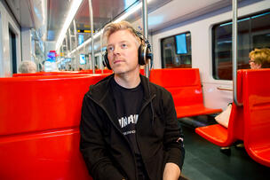 A man listening through headphones.
