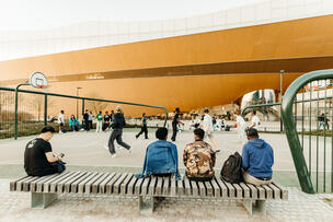 Basketball players in front of Oodi Helsinki Central Library.