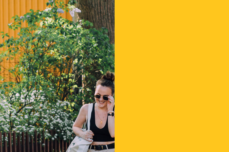 Kaksi ihmistä kävelee keltaisen talon edessä 