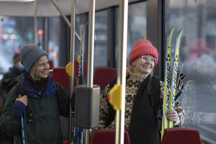 Naiset raitiovaunussa menossa hiihtämään. 